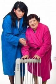 7985634-two-women-cold-shivering-in-their-house-and-trying-to-warm-with-an-electric-heater-9054903